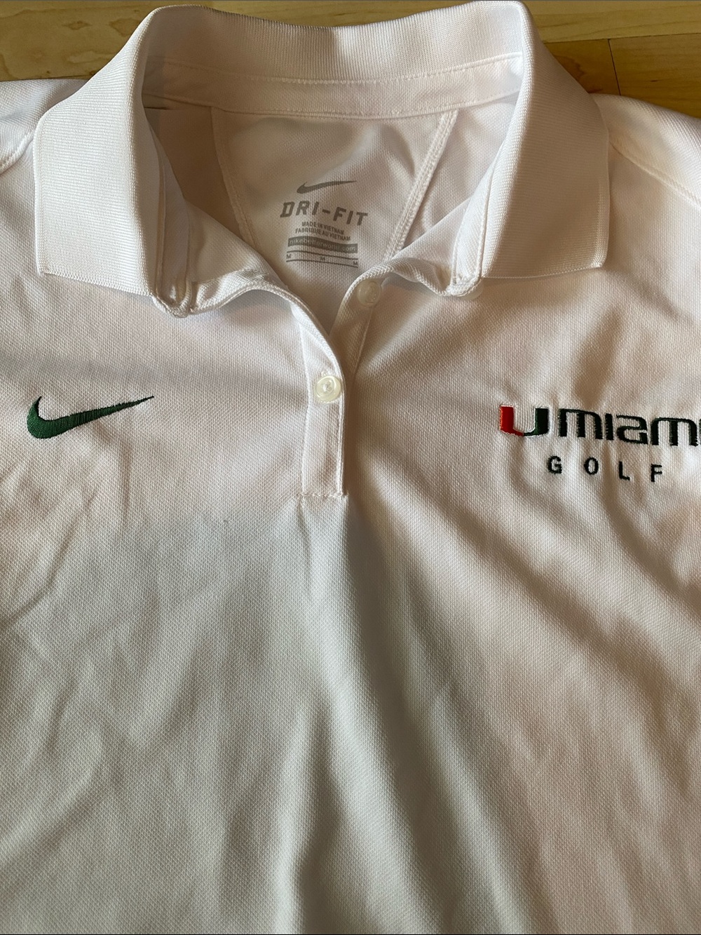 Women’s Nike White Polo with Green Swoosh and orange/green Miami Golf Logo - Picture 2 of 3